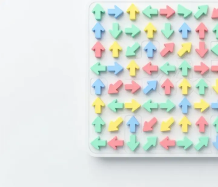 Pastel coloured puzzle board with geometric arrow tiles